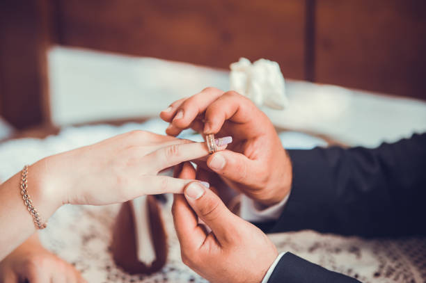 istock bride and groom holding hands.Declaration of Love. 999073596