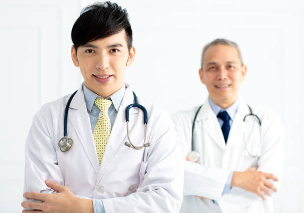 istock Portrait of two smiling asian doctors 999073894