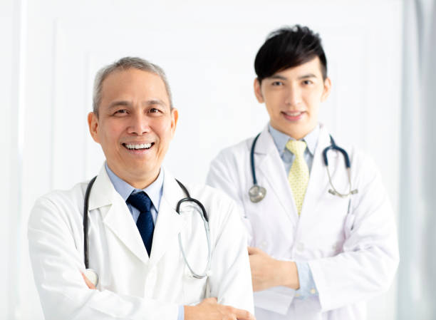 istock Portrait of two smiling asian doctors 999073896