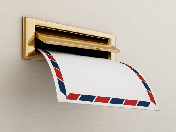 white enveloppe being delivered through the mail slot - doormat door christmas holiday imagens e fotografias de stock