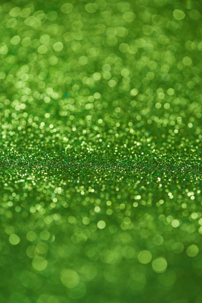 istock Green bokeh background of glitter lights 999077440