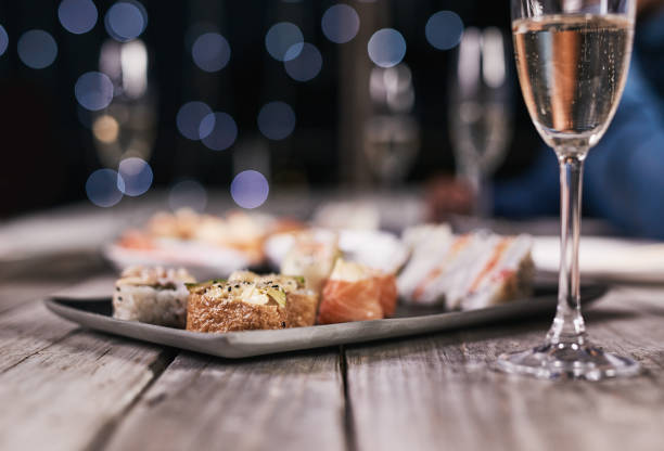 Sushi if you're not fussy Cropped shot of a variety of sushi on a plate and a glass of champagne restaurant food canapes appetizers stock pictures, royalty-free photos & images