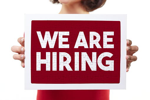 woman holding we are hiring puzzle