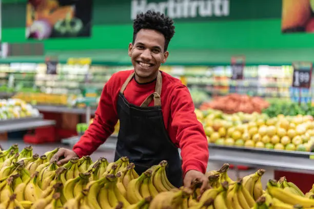 Photo of Supermarket Employee Portrait Choosing Bananas