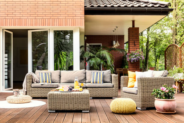 istock Yellow pouf on wooden patio 999093160
