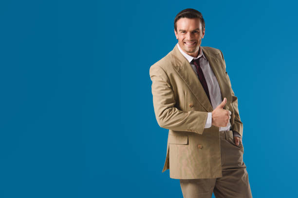 istock handsome happy man showing thumb up and smiling at camera isolated on blue 999096576