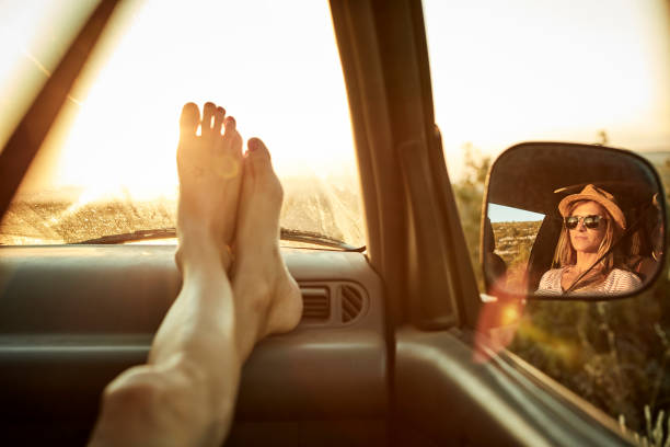Woman's feet relaxing on dashboard of mini van