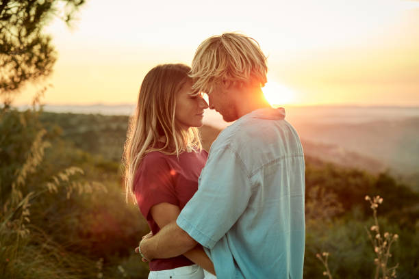 istock Couple embracing during road trip at sunset 999098462