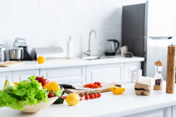 istock fresh healthy vegetables, cutting board and spices on kitchen table 999101412