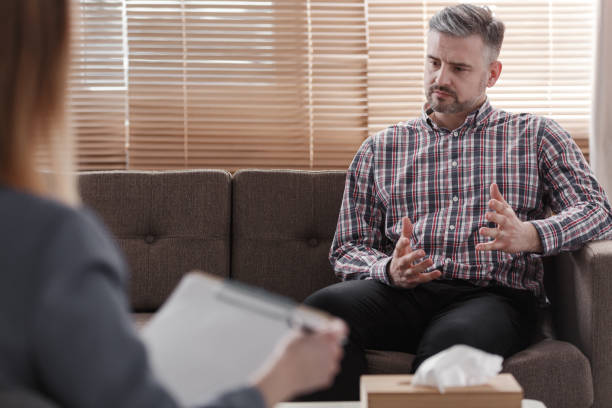 istock Handsome man gesticulating while talking to his psychologist during a therapy 999105244