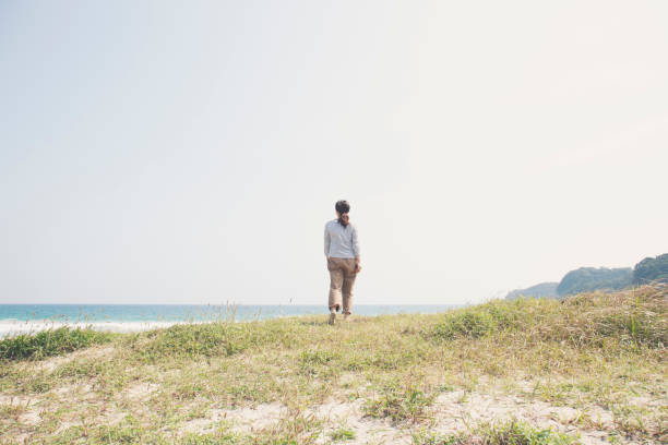 istock Woman walking at seaside 999115280