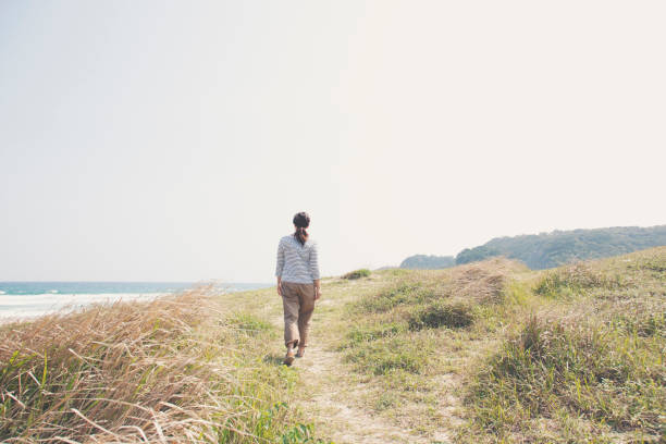 istock Woman walking at seaside 999115296