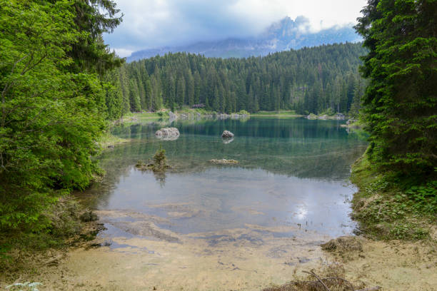 istock Lake Carezza with reflection of mountains in the Dolomites 999118496