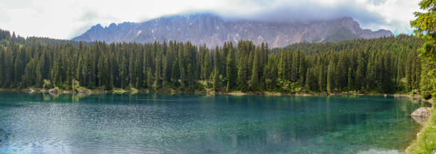 istock Lake Carezza with reflection of mountains in the Dolomites 999118534