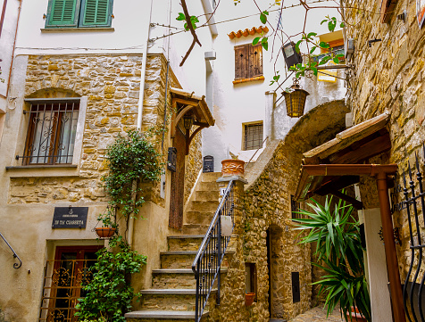 IMPERIA, LIGURIA, ITALY - APRIL 15, 2018 : Path between the alleys and stairway in the historical center of Seborga, counted among the most beautiful villages in Italy.