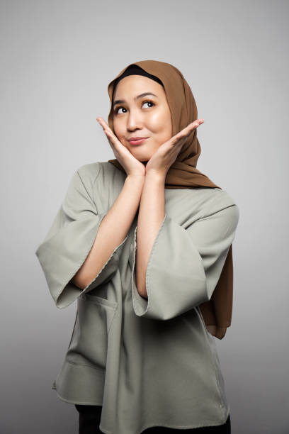 istock A women touch her face and smile with excitement 999128806