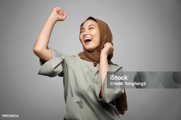 Excited Young Muslim Woman In White Background Stock Photo - Download Image Now - Women, Asia, Happiness