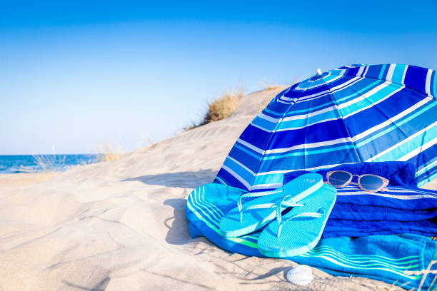 istock Summer, beach or holiday backgrounds: blue beach accessories on white sand dune 999131310