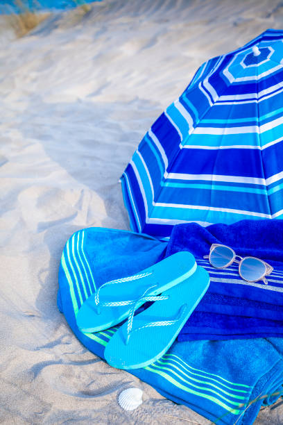 istock Summer, beach or holiday backgrounds: blue beach accessories on white sand dune 999131316