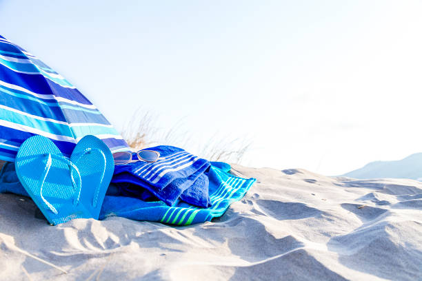 istock Summer, beach or holiday backgrounds: blue beach accessories on white sand dune 999132616