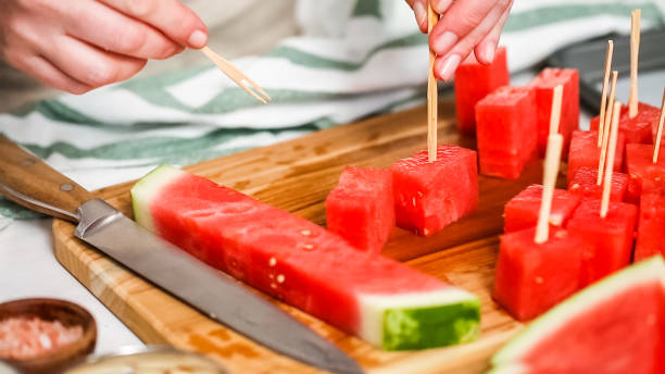 istock Slicing watermelon into cubes for preparing chocolate covered watermelon bites. 999140166