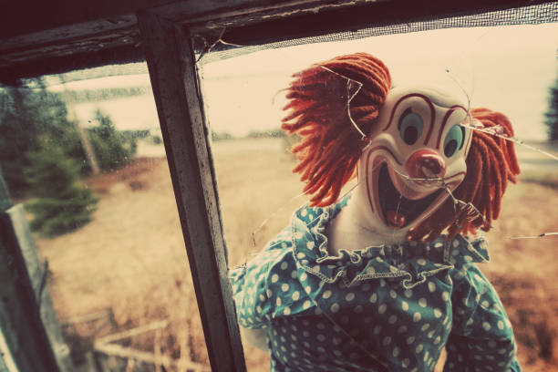 Creepy Clown in Window Creepy clown nightmare. creepy doll stock pictures, royalty-free photos & images