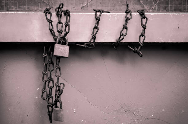 istock padlocks with chanes wrapped around metal bar 999164292