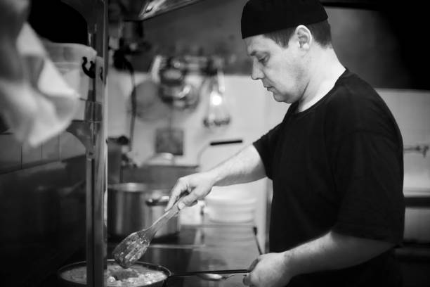 istock Chef in restaurant kitchen at stove with pan 999168706