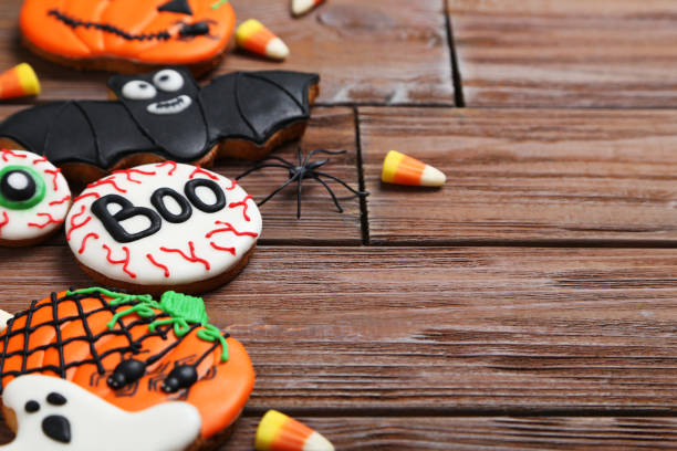 istock Fresh halloween gingerbread cookies on brown wooden table 999186062