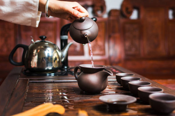 istock Woman traditionally preparing Chinese tea in a Tea ceremony 999186894