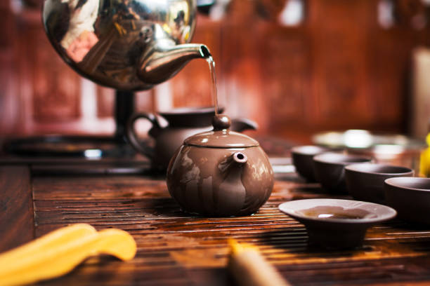 istock Woman traditionally preparing Chinese tea in a Tea ceremony 999187080