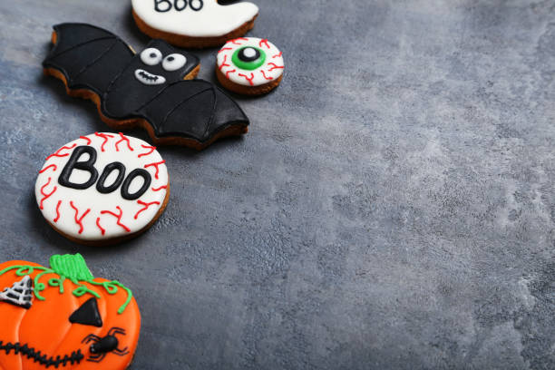 istock Fresh halloween gingerbread cookies on grey wooden table 999187720