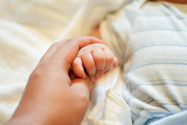 istock A Father Holding His Baby's Hand 999192224