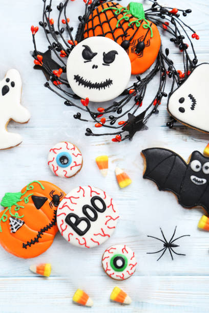 istock Fresh halloween gingerbread cookies on white wooden table 999194874