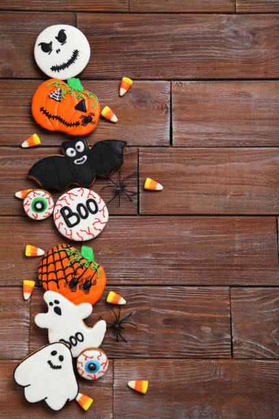 istock Fresh halloween gingerbread cookies on brown wooden table 999197184