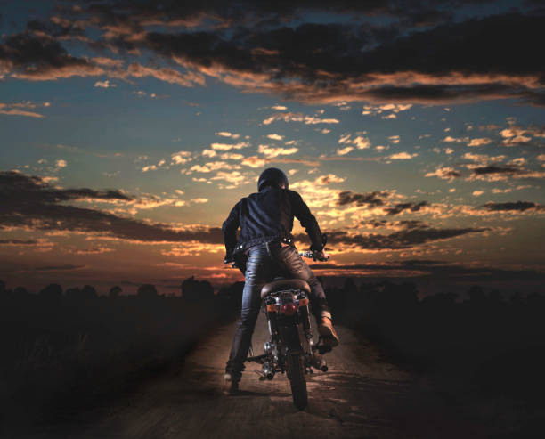 Biker with motorcycle retro styles. Retro style motorcycle with sunset sky background. motorcycle biker stock pictures, royalty-free photos & images