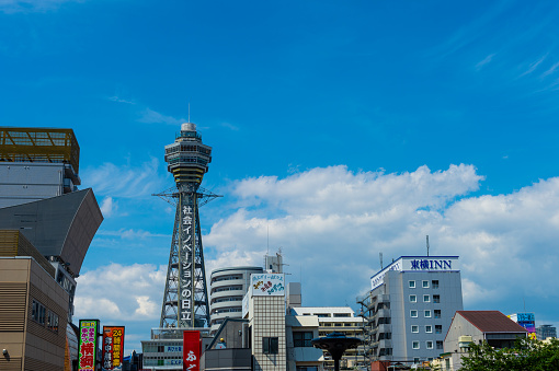 Osaka, JAPAN - CIRCA June, 2018: Tsutenkaku Tower  is a tower and well-known landmark of Osaka, Japan and advertises Hitachi, located in the Shinsekai district of Naniwa-ku, Osaka.
