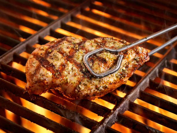 BBQ, Herb Chicken Breast BBQ, Herb Chicken Breast on the Grill serving tongs stock pictures, royalty-free photos & images