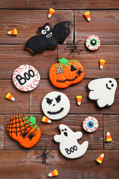 istock Fresh halloween gingerbread cookies on brown wooden table 999207242
