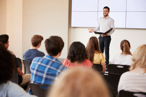 istock Teacher Giving Presentation To High School Class In Front Of Screen 999213972