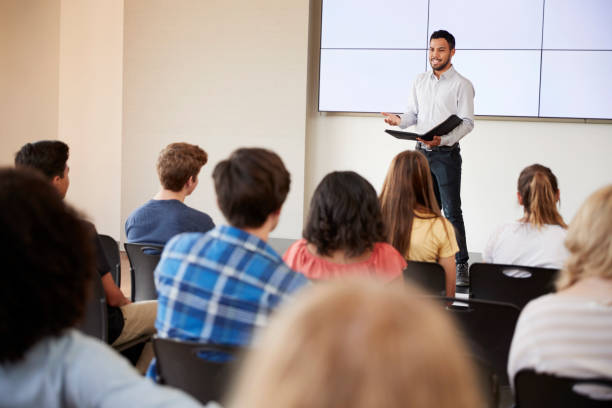 istock Teacher Giving Presentation To High School Class In Front Of Screen 999213974