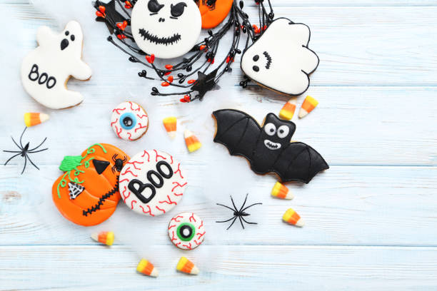 istock Fresh halloween gingerbread cookies on white wooden table 999216120