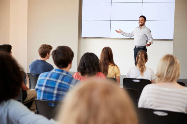 istock Teacher Giving Presentation To High School Class In Front Of Screen 999216356