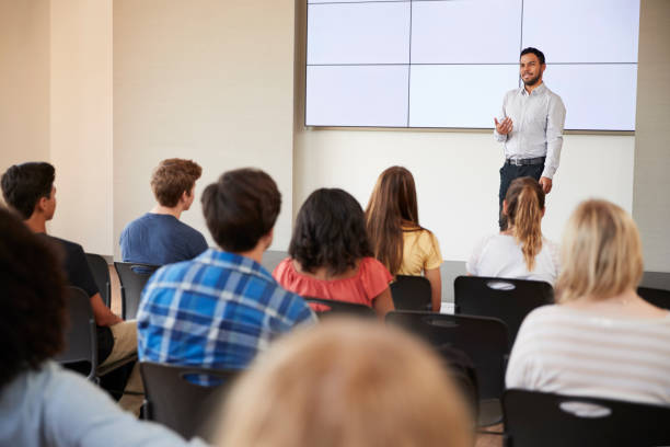 istock Teacher Giving Presentation To High School Class In Front Of Screen 999216360