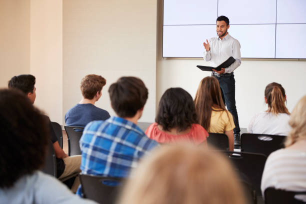 istock Teacher Giving Presentation To High School Class In Front Of Screen 999217220