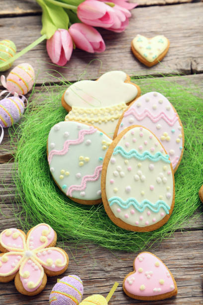 istock Easter cookies in green nest on wooden table 999217632