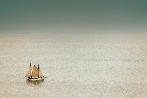 old and antique sailboat with vintage effect on the sea
