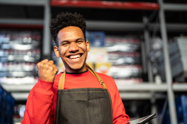 istock Man having good news on tablet at a warehouse 999221896