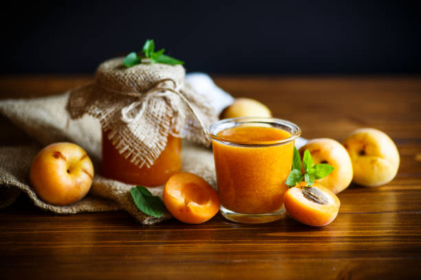 fresh sweet apricot jam isolated on a wooden table