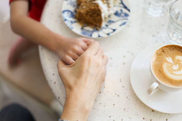 istock Mother And Son Holding Hands At A Cafe 999226528